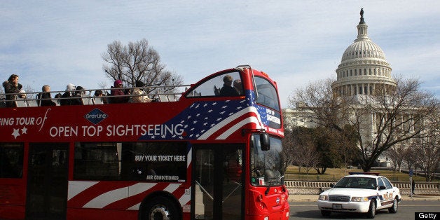 WASHINGTON, DC - FEBRUARY 17: A tourist bus drives past the U.S. Capitol building, on February 17, 2012 in Washington, DC. Earlier today the FBI arrested a man with possible ties to al-Qaeda, for plotting to blow up the U.S. Capitol building in an apparent suicide attack. (Photo by Mark Wilson/Getty Images)