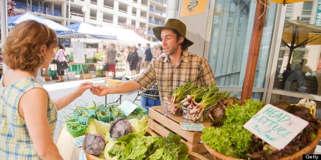 UNITED STATES - JUNE 08: Michael James, of Blueberry Hill Farm in Clearspring, Md., helps a customer at the NOMA farmer's market at 1st and M Streets, NE . (Photo By Tom Williams/Roll Call)
