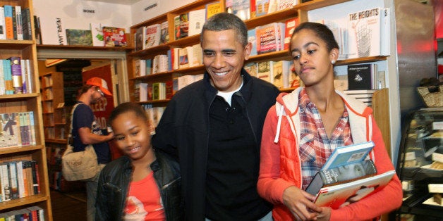 WASHINGTON, DC - NOVEMBER 26: U.S. President Barack Obama and daughters Sasha (left) and Malia shop for books in the Kramerbooks book store on November 26, 2011 in Washington, DC. Obama and family will attend a basketball game at Towson University later in the day, with Michelle Obama's brother, Craig Robinson, coaching the visiting Oregon State Beavers. (Photo by Martin H. Simon-Pool/Getty Images)