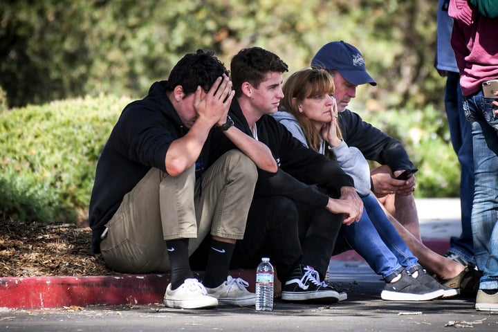 People awaiting word of loved ones after the Borderline Bar & Grill shooting sit outside the Alex Fiore Teen Center in Th