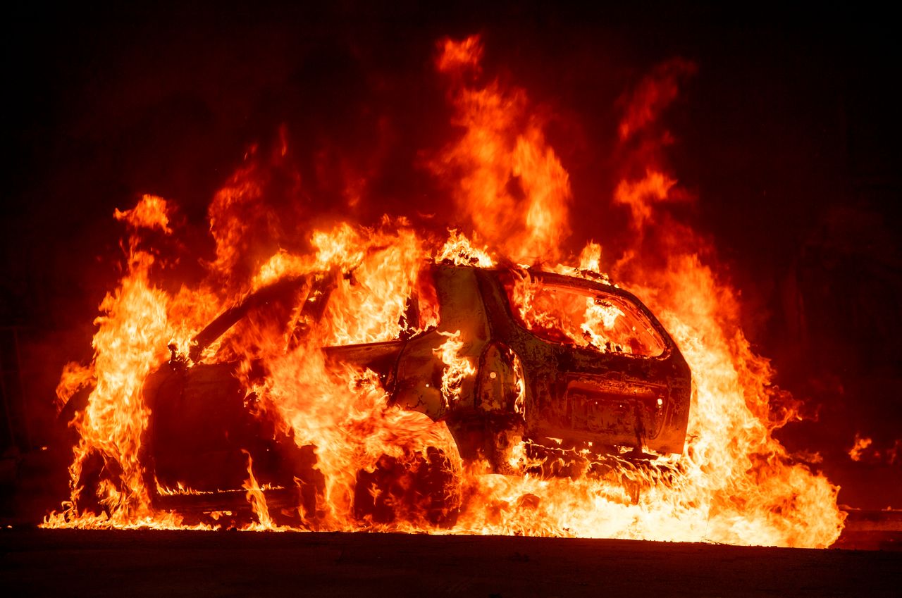 A car explodes into flames as the Camp fire tears through downtown Paradise, California on Nov. 8.