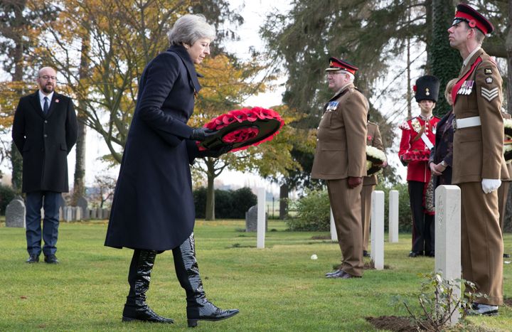 Theresa May and Charles Michel (far left) attend a ceremony to commemorate Armistice Day in Belgium.