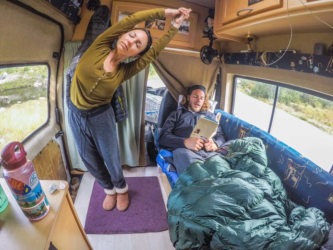 Brittany and Drew relaxing inside their van the day after summiting the highest peak in Norway, August 2017.