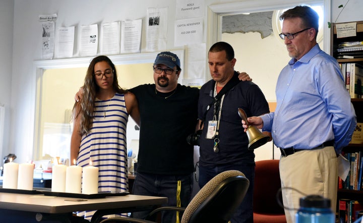 Rick Hutzell, right, the editor of The Capital Gazette, is joined by reporter Selene San Felice and photojournalists Paul W.