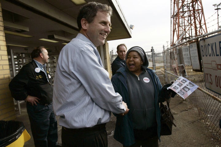 Brown shakes hands with workers as they leave the Ford Engine Plant in 2006 in Brook Park, Ohio.