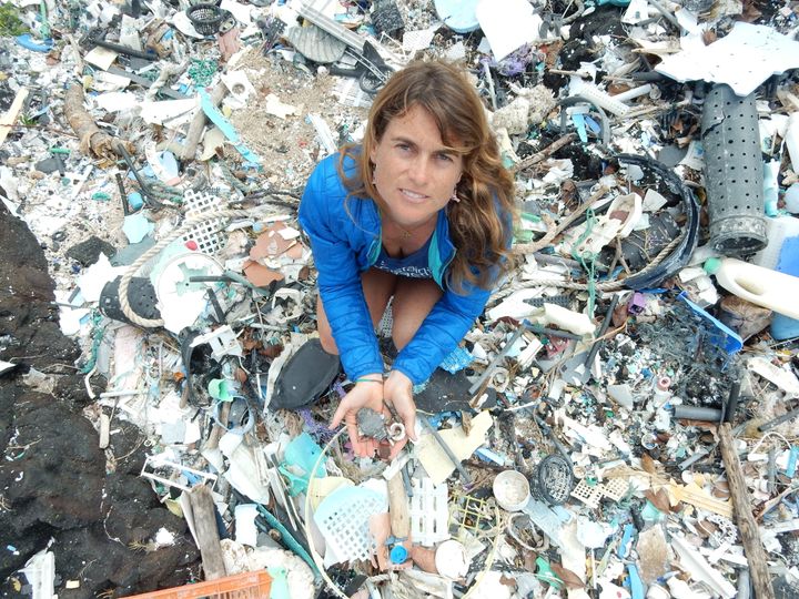 Sarah-Jeanne Royer stands atop a mound of plastic debris. Earlier this year, she found that ocean plastics can decay into greenhouse gases.