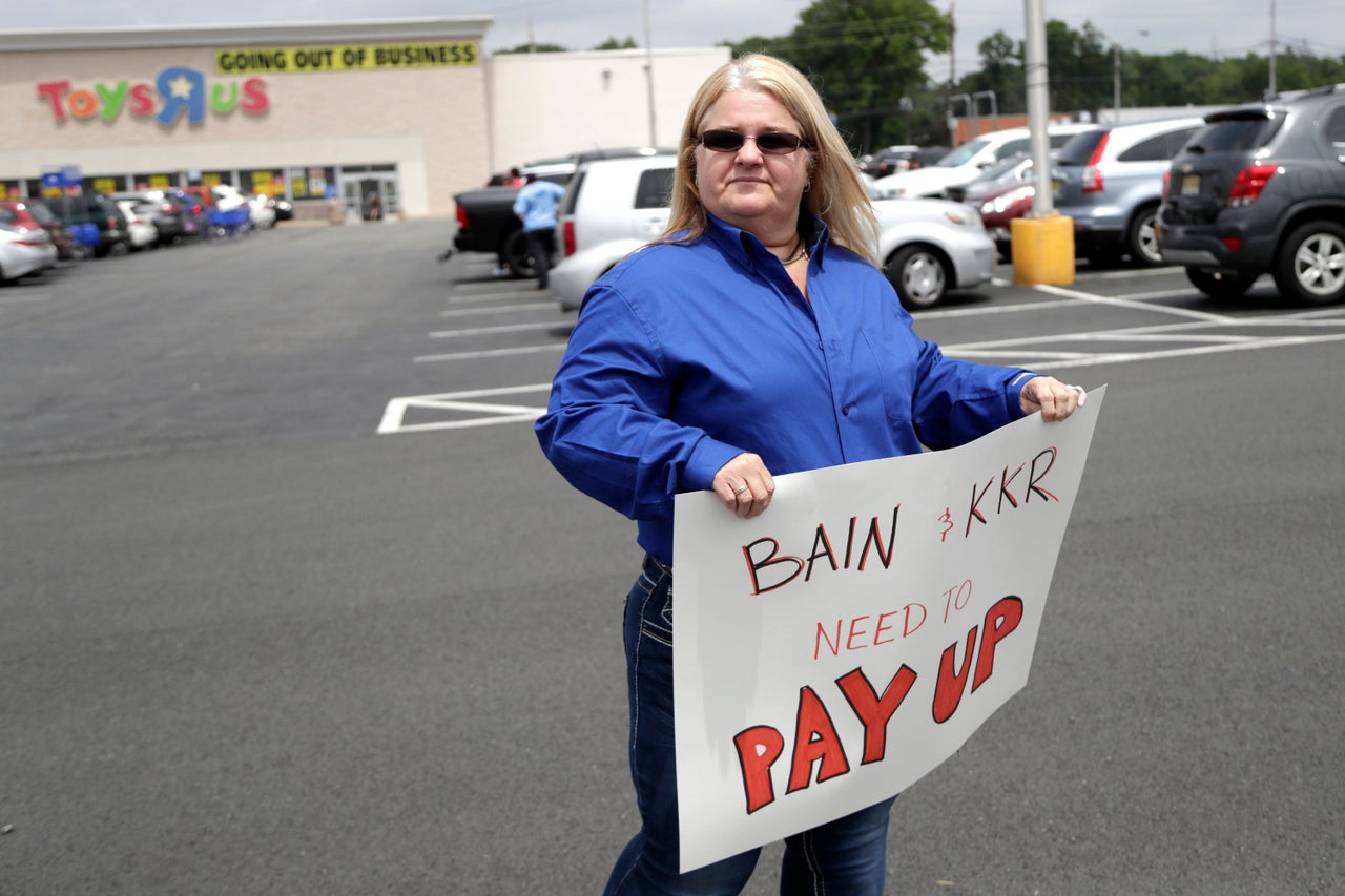 Cheryl Claude, an assistant manager at the Toys R Us store in Woodbridge, New Jersey, holds a sign in front of the Totowa, location on June 1, after the company announced that employees will not get severance packages once the stores are closed.