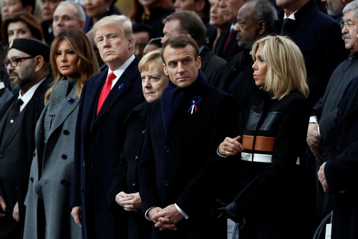 U.S. President Donald Trump and first lady Melania Trump; German Chancellor Angela Merkel; and French President Emmanuel Macron and his wife, Brigitte Macron, attend Sunday's commemoration of Armistice Day at the Arc de Triomphe in Paris.
