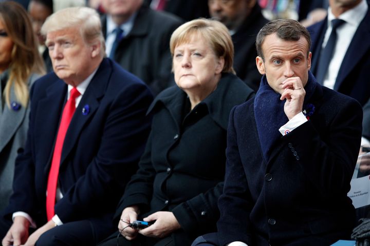 US President Donald Trump, left, German Chancellor Angela Merkel and French President Emmanuel Macron attend ceremonies at the Arc de Triomphe on Sunday.