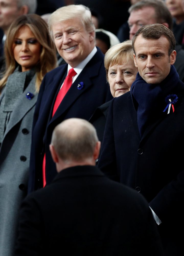Russian President Vladimir Putin arrives to take his place with French President Emmanuel Macron, Brigitte Macron, German Chancellor Angela Merkel, US President Donald Trump and first lady Melania Trump to attend a commemoration ceremony for Armistice Day.