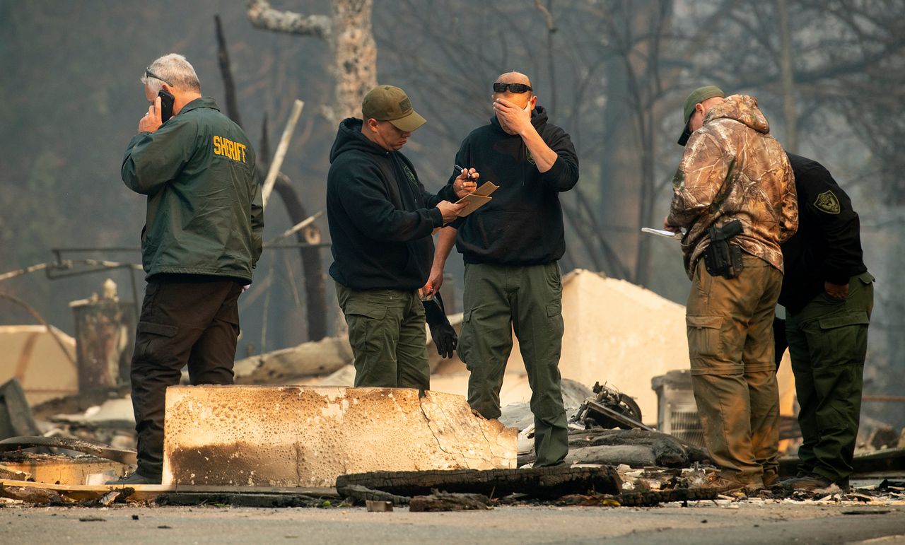 Sheriff's deputies recover the remains of Camp Fire victims on Saturday in Paradise, Calif.