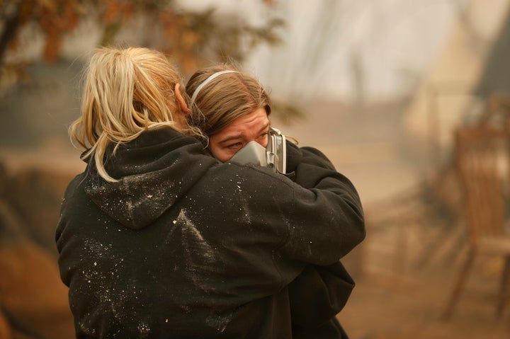 Krystin Harvey, left, comforts her daughter Araya Cipollini at the remains of their home burned in the Camp Fire, Saturday, N