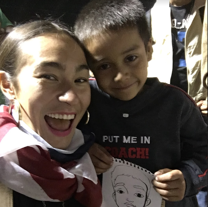 Artist Scarlett Baily in Mexico City with a child in the migrant caravan.