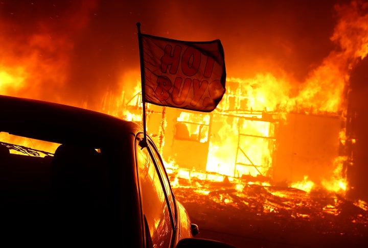 The Camp fire moves through a car dealership on Nov. 8, 2018, in Paradise, California. Fueled by high winds and low humidity, the rapidly spreading wildfire has ripped through the town of Paradise, charring 18,000 acres and destroying dozens of homes in a matter of hours. 