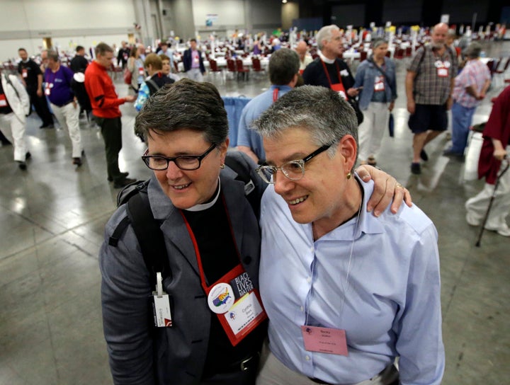 The Rev. Cynthia Black (left), and her spouse, Becky Walker, speak with a reporter after Episcopalians voted to allow religious weddings for same-sex couples, July 1, 2015, in Salt Lake City.