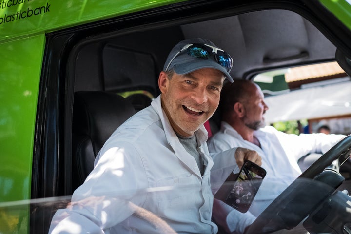 Fisk Johnson sits in the driver's seat of Plastic Bank's mobile collection van in Denpasar, Bali, Indonesia.