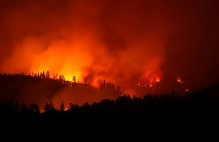 The Camp fire burns in the hills near Oroville, California, on Sunday.