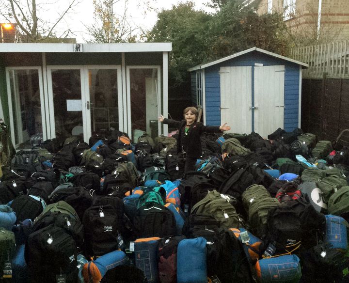 Jacob with hundreds of backpacks he had managed to fill through his campaign. 