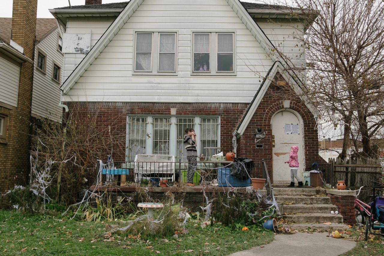 Fritz and her 4-year-old daughter, Honesty, remove Halloween decorations from their front porch and lawn on Nov. 12.