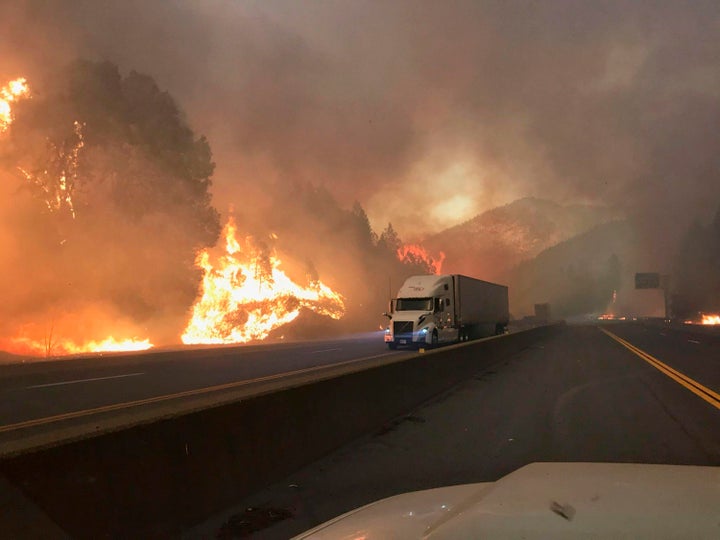 A truck drives next to the Delta fire along Interstate 5 near Shasta-Trinity National Forest, California, on Sept. 5, 2018.