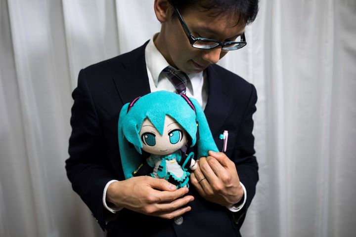 Groom Akihiko Kondo, 35, with a Hatsune Miku stuffed doll at the wedding.