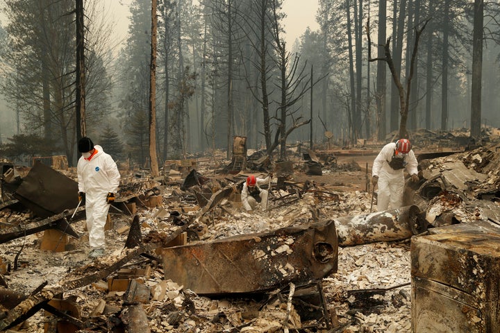 Search and rescue workers search for human remains at a trailer park burned in the Camp fire on Nov. 13, 2018, in Paradise, California.