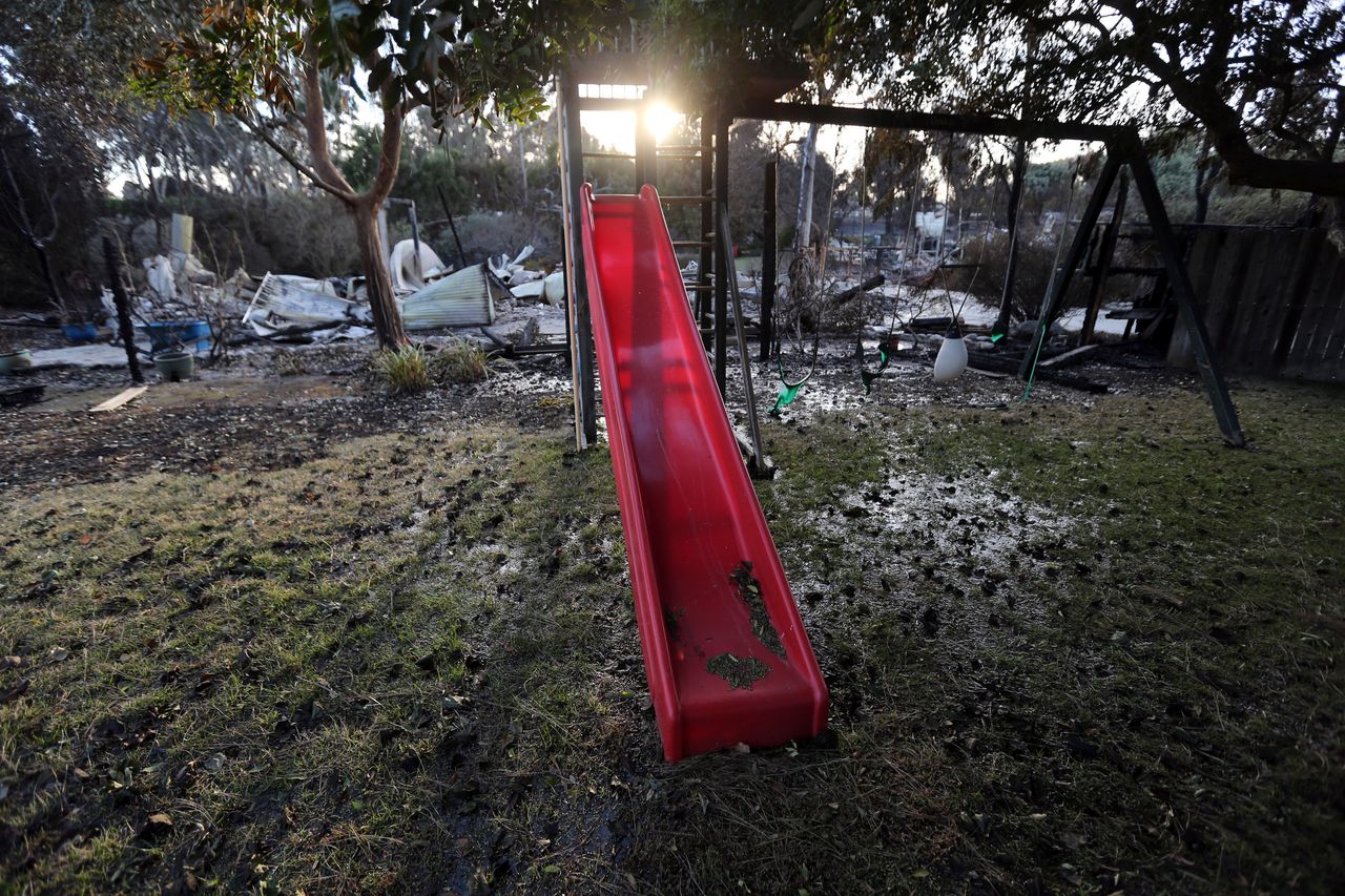 A child's slide and swingset stand behind a home destroyed by the Woolsey fire on Dume Drive in the Point Dume area of Malibu in Southern California, Tuesday, Nov. 13.