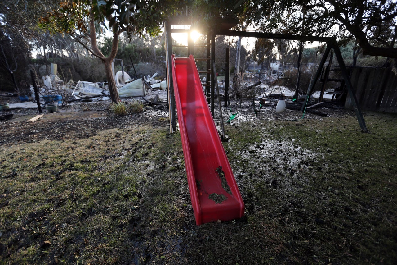 A child's slide and swingset stand behind a home destroyed by the Woolsey fire on Dume Drive in the Point Dume area of Malibu in Southern California, Tuesday, Nov. 13.