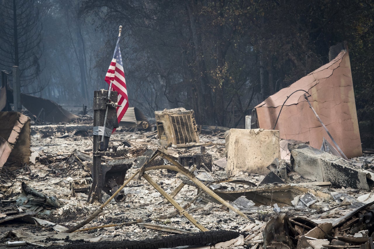 An American flag stands among burned rubble in Paradise, California, on Nov. 13. The Camp fire north of Sacramento has killed at least 42 people, injured three firefighters and destroyed 6,500 homes.