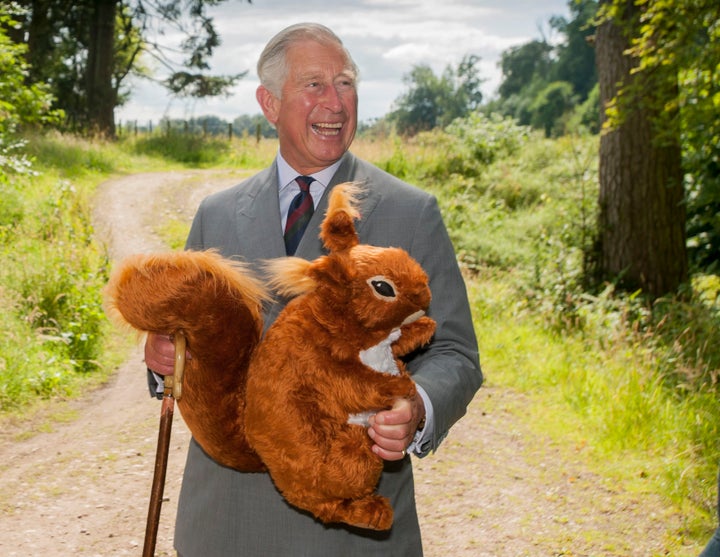 The Prince of Wales receives a toy red squirrel for Prince George, presented by the Scottish Wildlife Trust during the visit