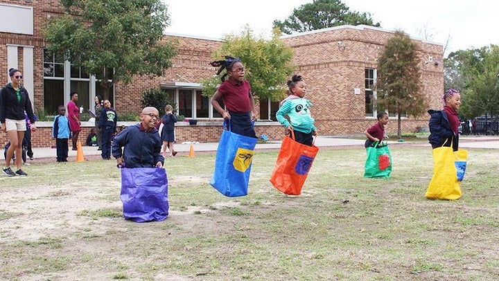 Kids at the Dufrocq School in Baton Rouge, Louisiana, compete in a sack race using equipment provided by the local parks and recreation commission. 