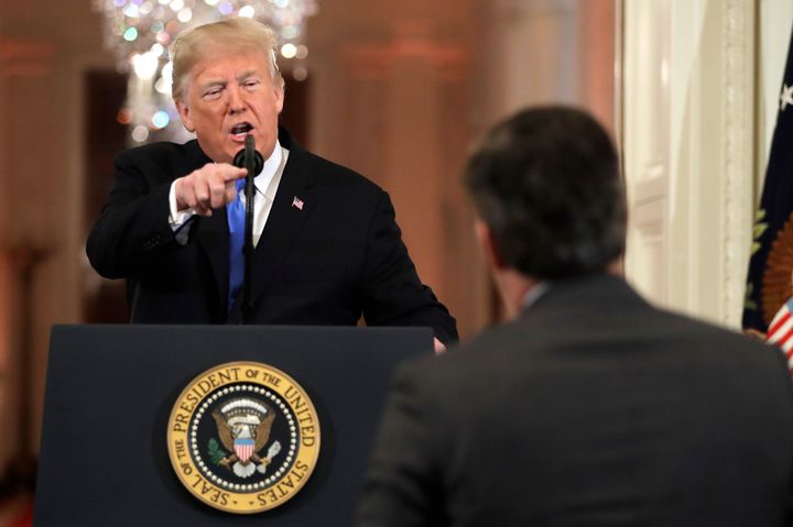 President Donald Trump points to CNN's Jim Acosta as he speaks during a news conference in the East Room of the White House l