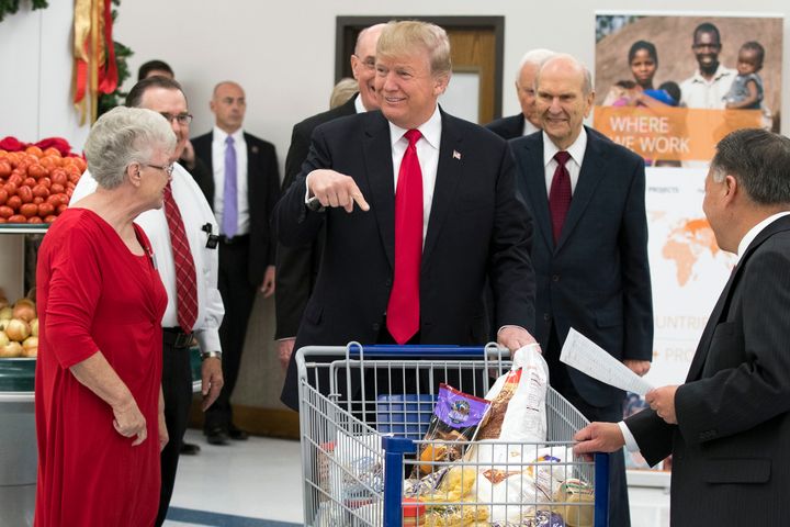 President Donald Trump points to his shopping cart during a tour of the Church of Jesus Christ of Latter-Day Saints Welfare Square food distribution center in December 2017 in Salt Lake City.