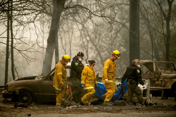 Firefighters recover the body of a Camp fire victim at the Holly Hills Mobile Estates on Wednesday in Paradise, California. Thousands of homes were destroyed when flames hit Paradise, a former gold-mining camp popular with retirees. 