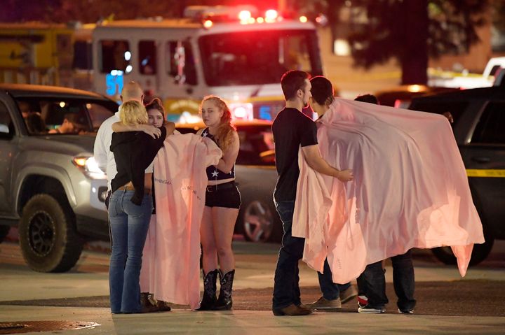 People comfort each other as they stand near the Borderline Bar & Grill in Thousand Oaks, Calif., in the early hours of Thursday, Nov. 8, 2018, after a gunman opened fire in the dance hall.