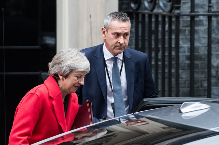 British Prime Minister Theresa May was barely clinging to power Thursday after two top officials resigned in the wake of her