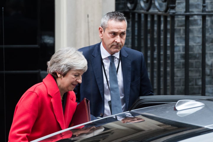 British Prime Minister Theresa May was barely clinging to power Thursday after two top officials resigned in the wake of her proposed Brexit deal.