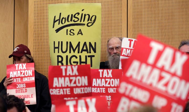 Protesters at a Seattle City Council meeting. Earlier this year, the city passed a law that would have taxed large corporations, including Amazon, to fund homelessness services. The law was repealed after Amazon funded a campaign against it.