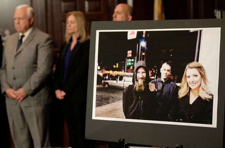 A picture of Katelyn McClure, right, Mark D'Amico, center, and Johnny Bobbitt Jr., left, displayed during a news conference i