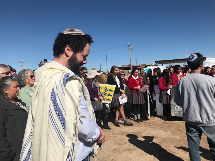 Rabbi Josh Whinston (front) and others gather outside the Tornillo detention camp in Texas on Thursday to protest the detainment of migrant children. 