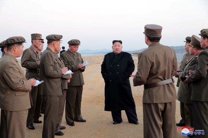 Kim, his officials and their ubiquitous notebooks.