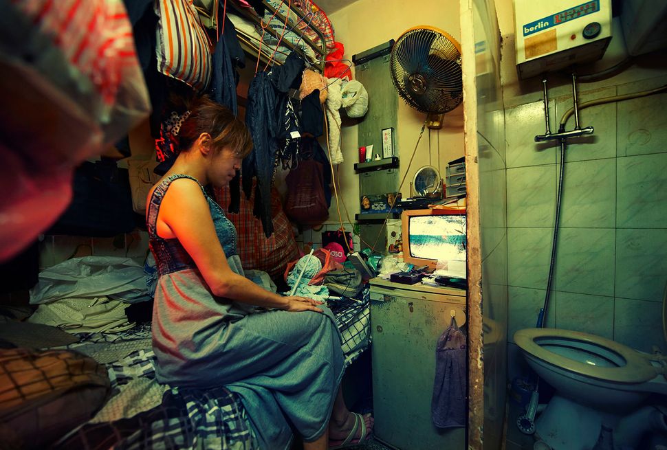 A subdivided unit in the Kowloon area of Hong Kong highlights the cramped conditions in which many are forced to live.
