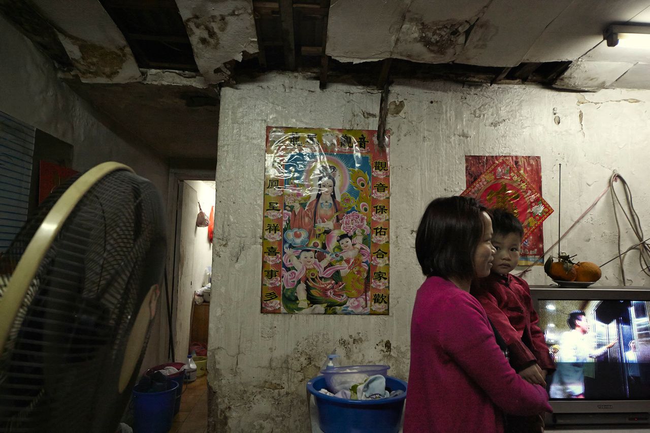 A young family in one of many poorly maintained subdivided apartments in Hong Kong. The average wait for public housing is 5.5 years.
