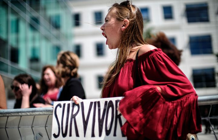 Meghan Downey of Chatham, New Jersey, protests in Arlington, Virginia, as U.S. Education Secretary Betsy DeVos announces changes in federal policy on rules for investigating sexual assault reports on college campuses on Sept. 7, 2017. 