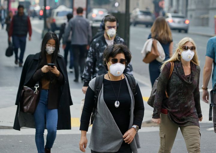 Pedestrians in San Francisco's Financial District wear protective masks against the hazardous air.