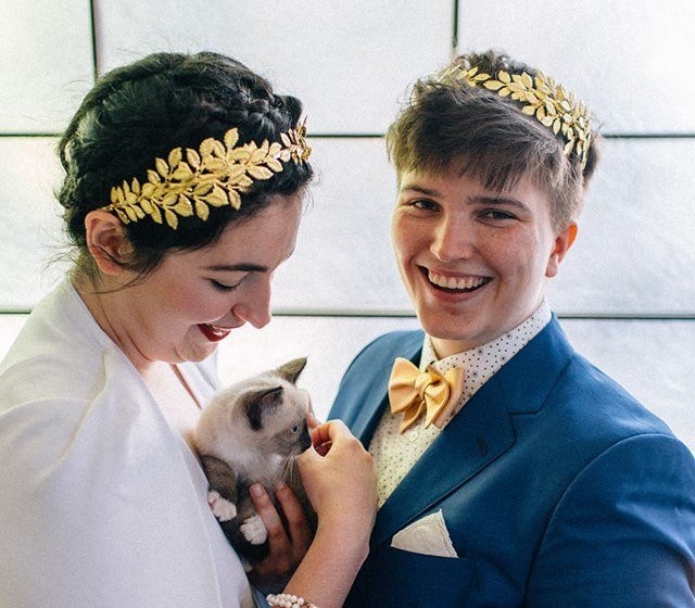 Colleen (left), a kitty and Iz on their wedding day.