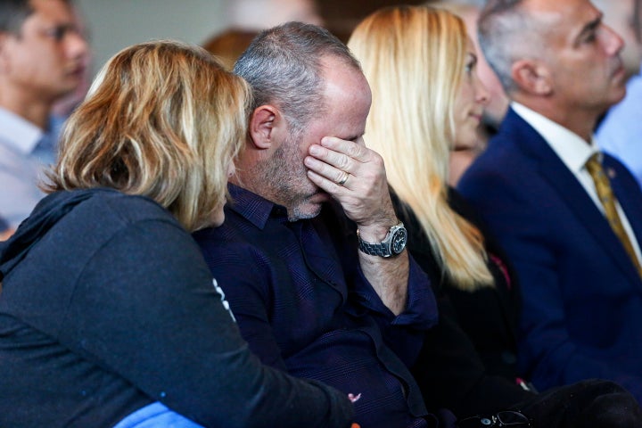Fred Guttenberg, whose daughter, Jamie, was killed in the Parkland school shooting, right, cries while his wife Jennifer comf