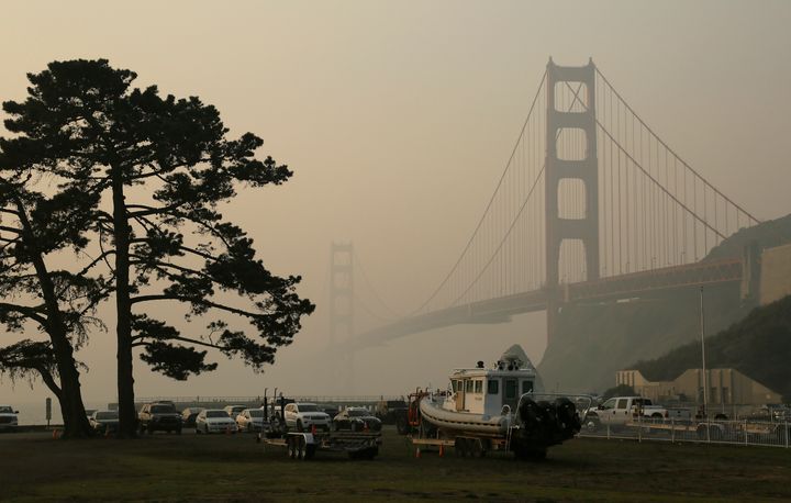 The Golden Gate Bridge is obscured by smoke and haze from wildfires Friday.