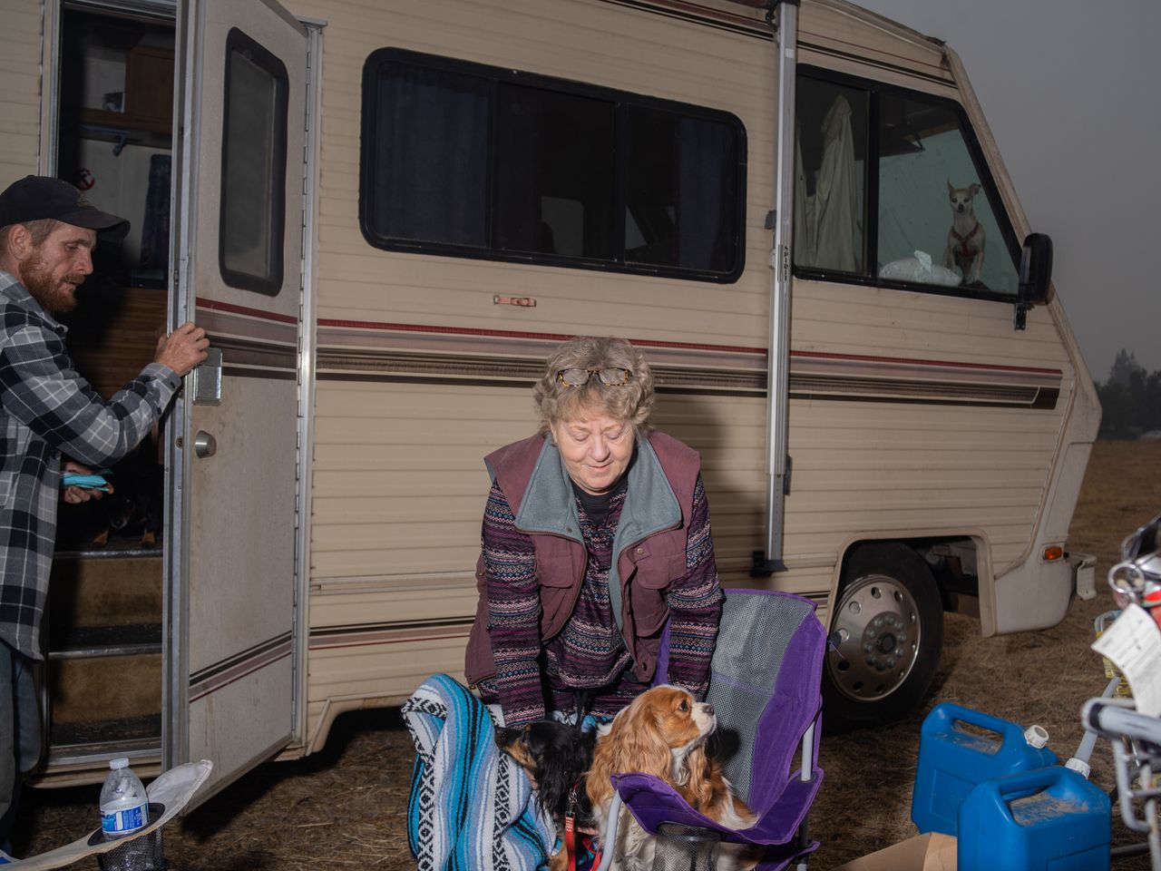 A family from Magalia, California, gathers in a Walmart parking lot in nearby Chico with their pets. Gail, center, plans to move to San Luis Obispo to stay with her cousins.