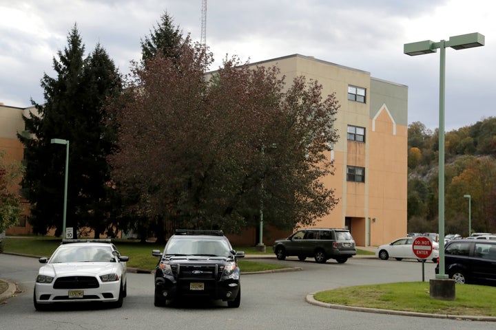 Police cruisers are seen parked near the entrance of the Wanaque Center for Nursing and Rehabilitation in Haskell, New Jersey.